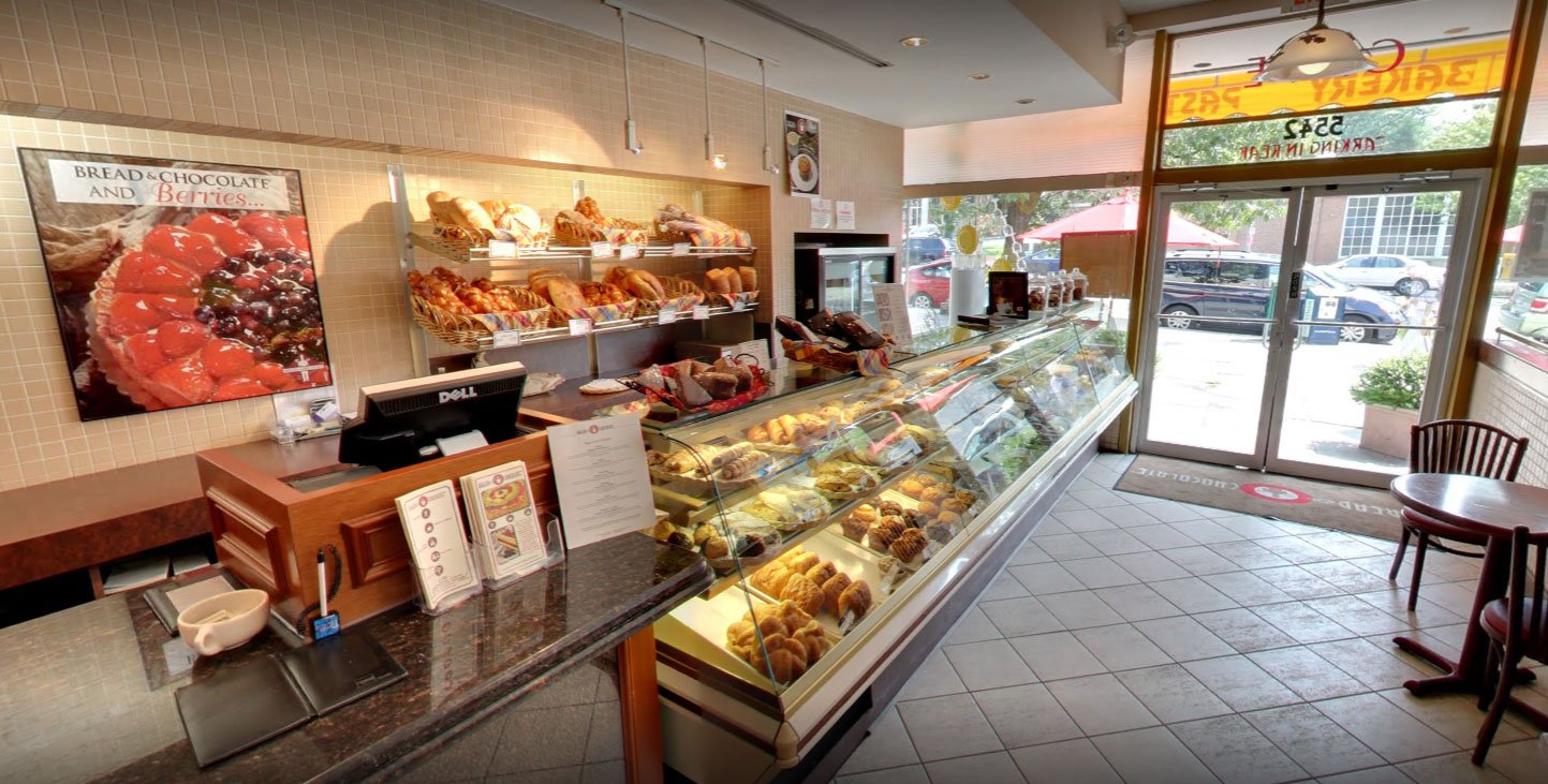 Bakery case filled with fresh croissants and pastries